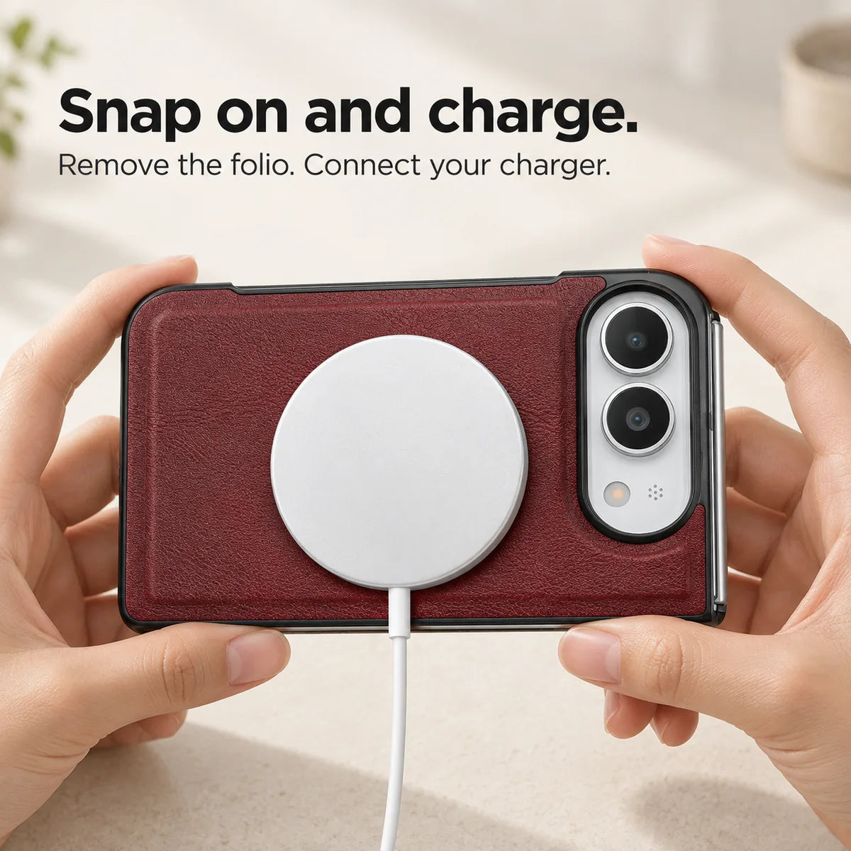 Burgundy phone case held horizontally with a magnetic charging puck attached to the rear. #color_Burgundy