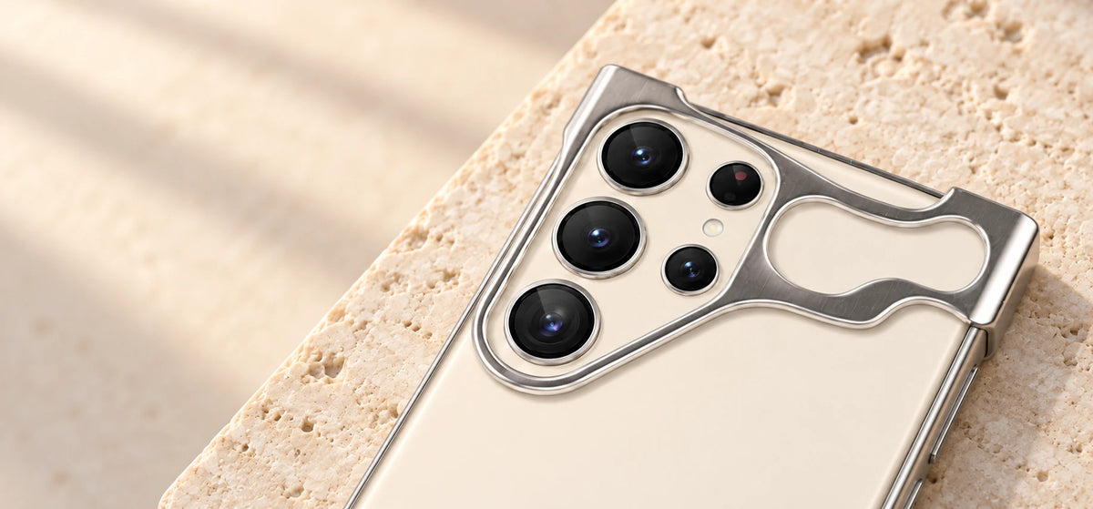 Close-up of a silver guard around vertically arranged phone cameras.