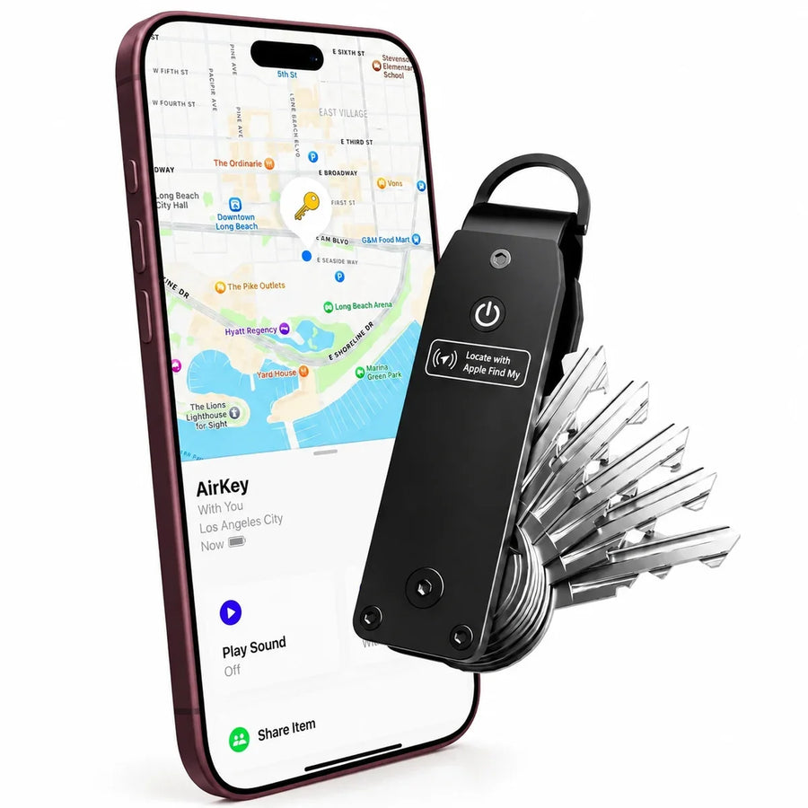 Stealth Black tracking key organizer beside a Burgundy iPhone showing its location in Find My.