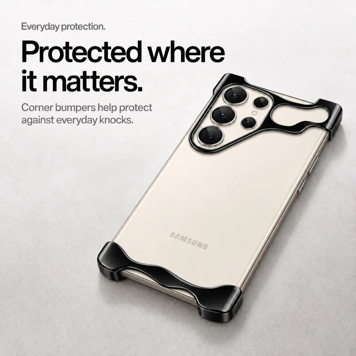 Black open metal phone bumper case lying on a desk with raised corner protection #color_Black