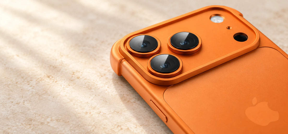 Close-up of an orange camera cover with three glass lens covers and small rounded corner guards.