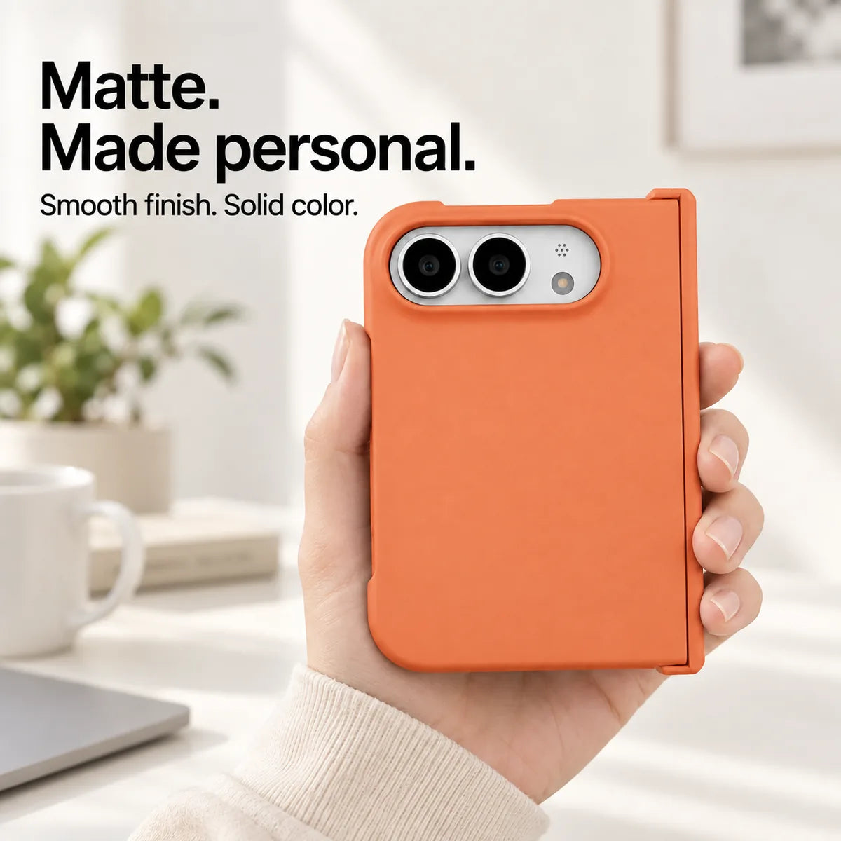 Orange matte iPhone Ultra case held in one hand, with a smooth solid-color rear shell and silver camera area. #color_Sunset Orange