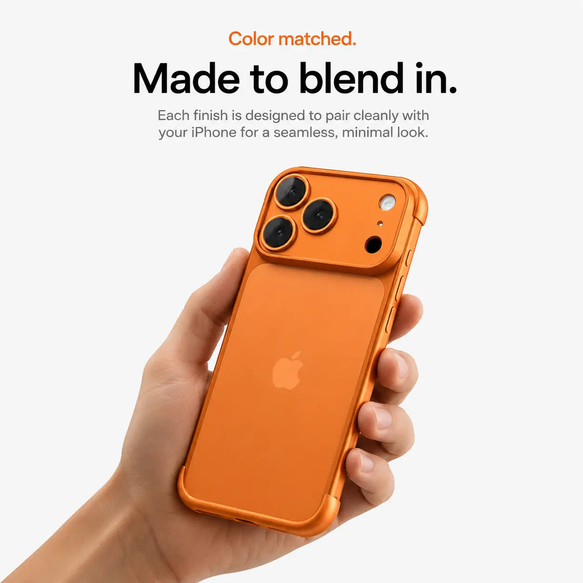 Orange open-back phone bumper held upright in one hand #color_Cosmic Orange