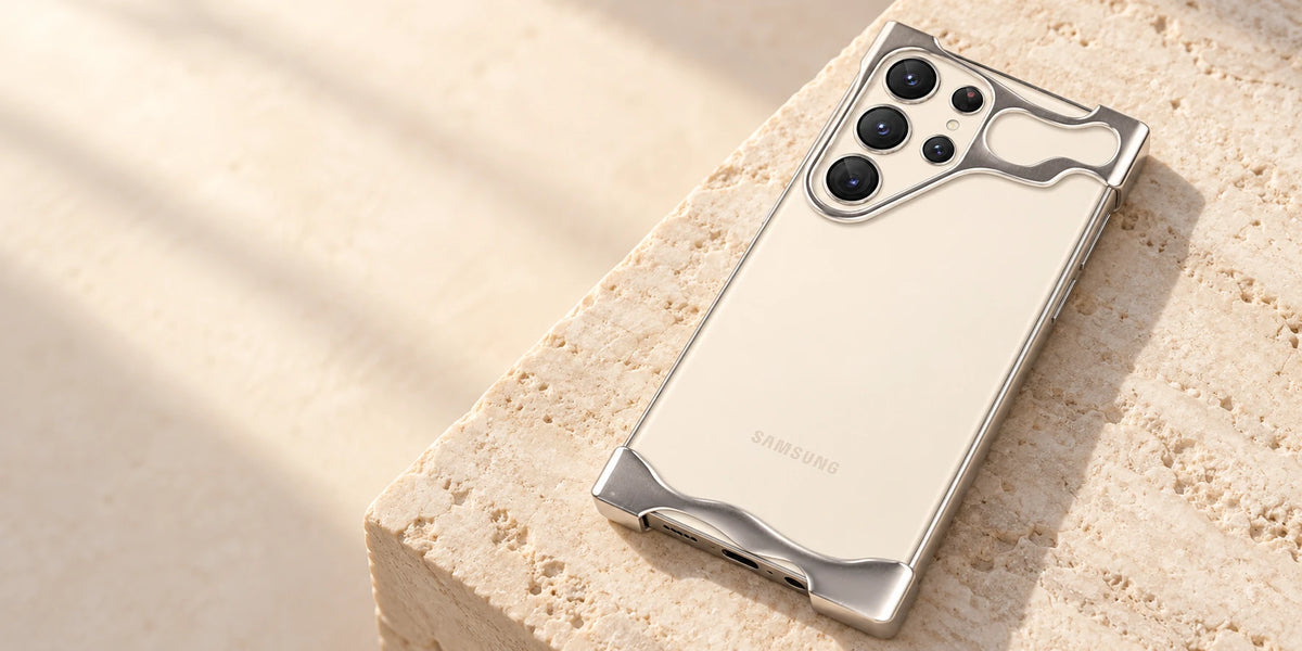 Silver metal guards framing the exposed back of a cream phone.